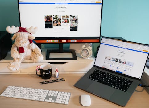A well-organized home office desk featuring a monitor, laptop, and playful decor for a comfortable workspace.